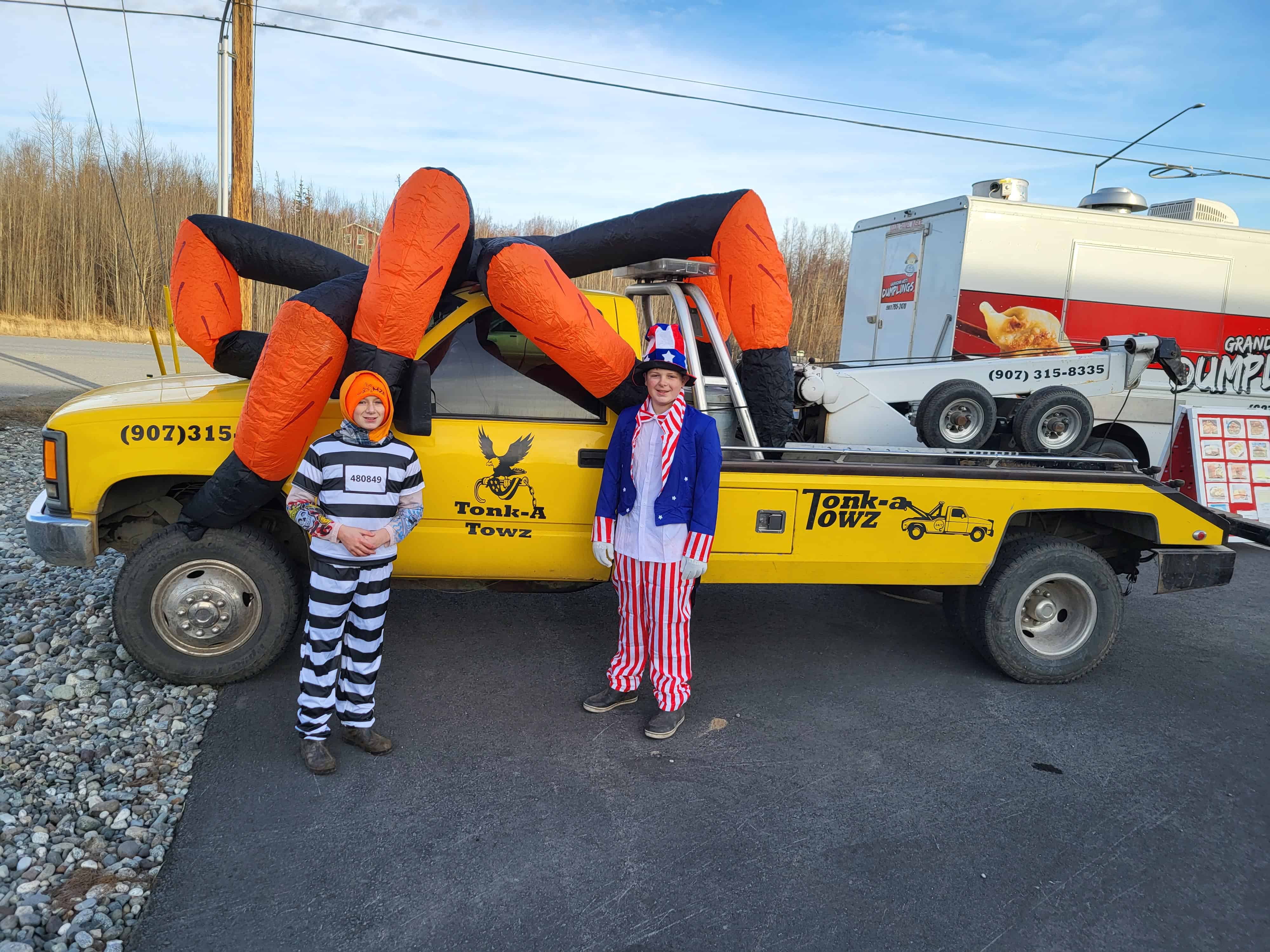 tonka towz truck decorated for Halloween with children.