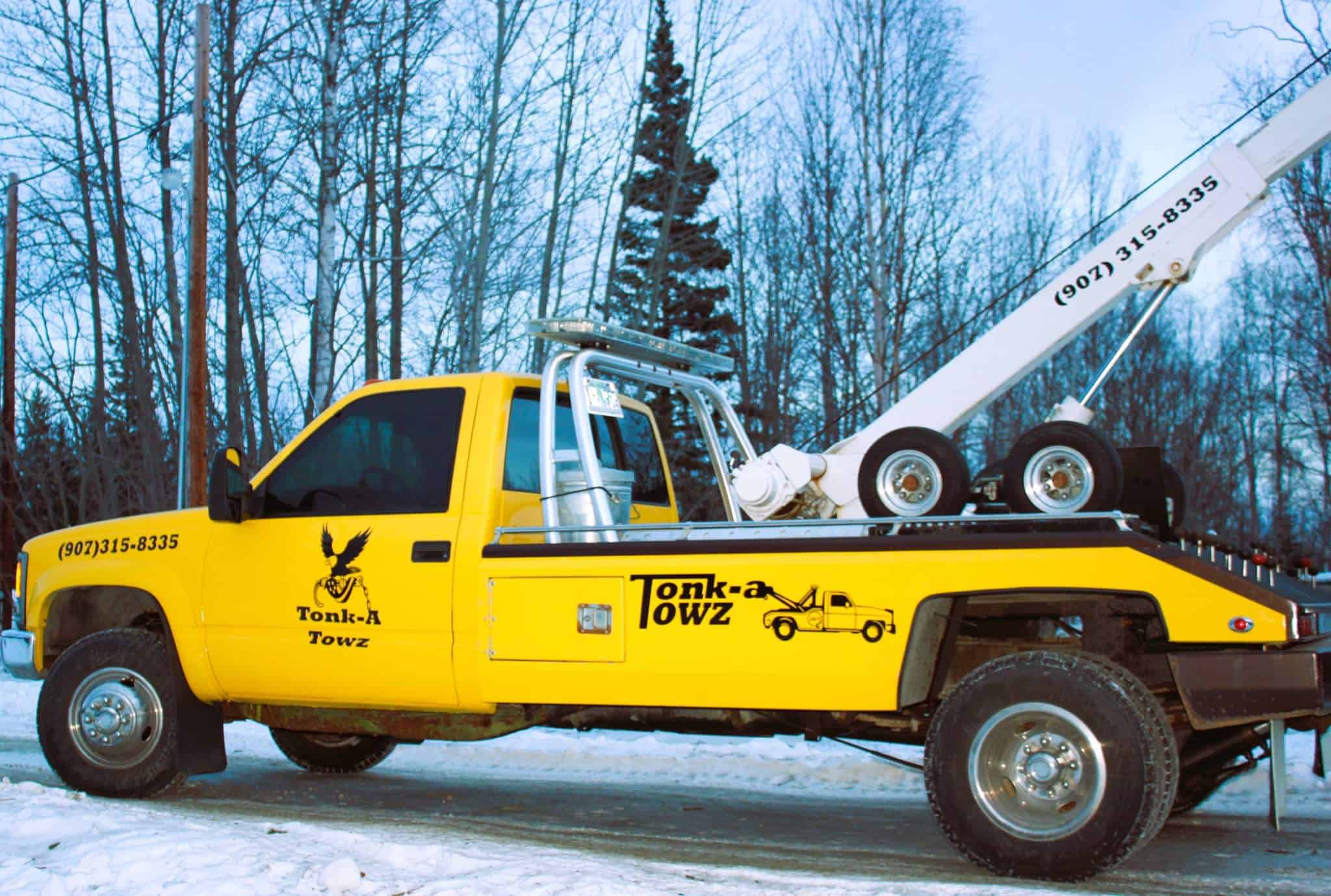 side view of yellow tonka towz truck.
